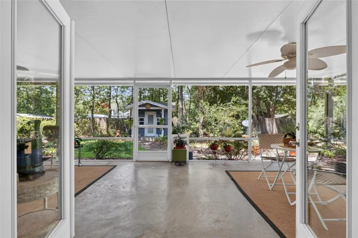 LEAVING FAMILY ROOM THROUGH DOUBLE DOORS TO SCREEN PORCH