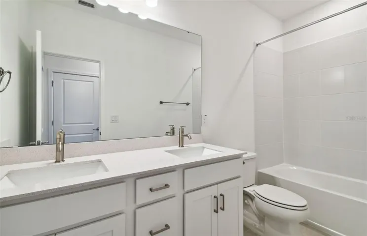 Upstairs hall bathroom with double Quartz sink vanity and shower/tub combo