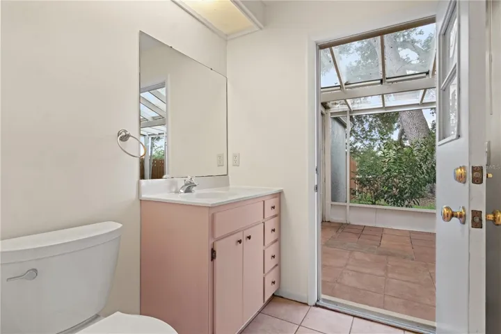 Downstairs bath leads out to the covered and screened lanai