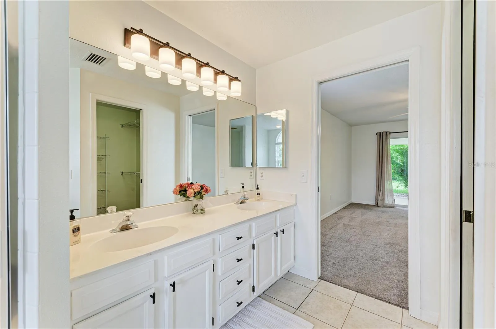 Primary bathroom with dual sinks shower and soaking tub