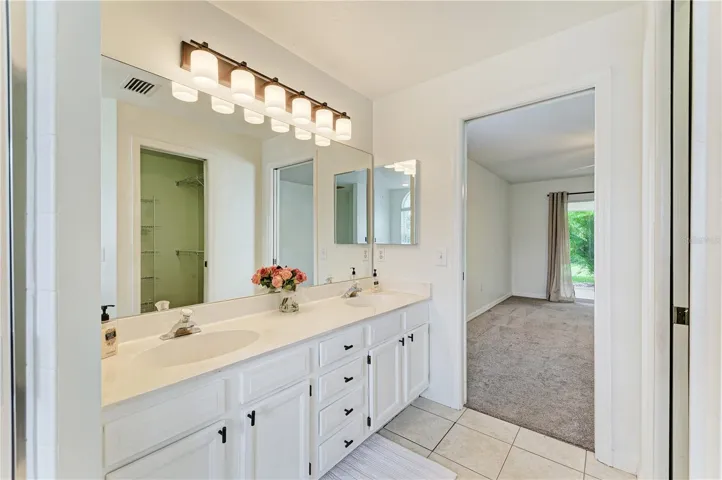 Primary bathroom with dual sinks shower and soaking tub