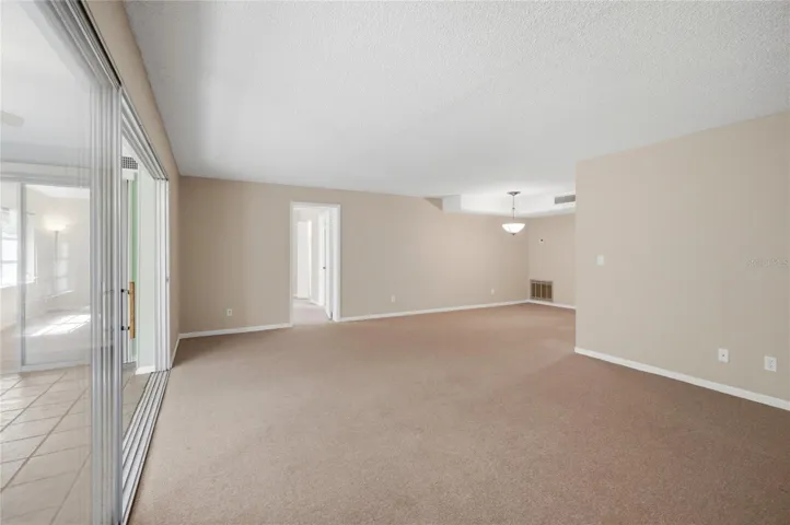SUNROOM/LIVING ROOM/PRIMARY BEDROOM/DINING