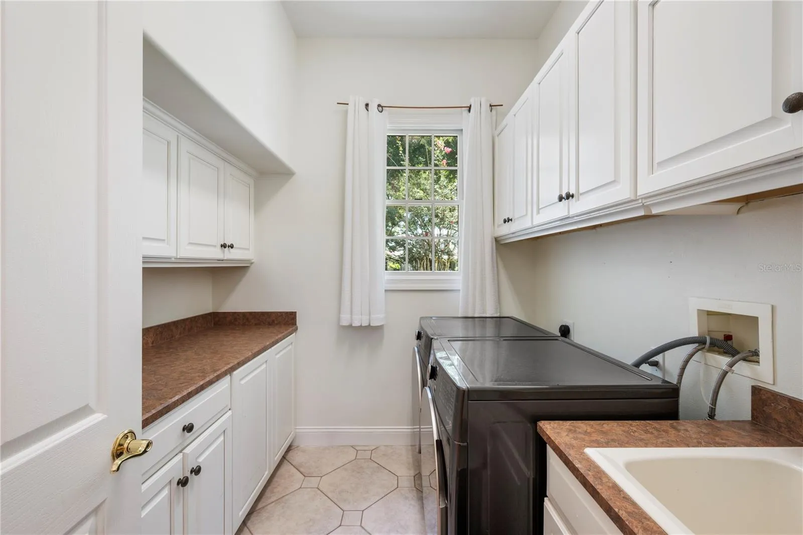 Spacious, bright laundry room with abundant storage