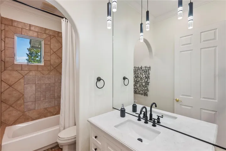 Full bath to service rear bedroom and pool.