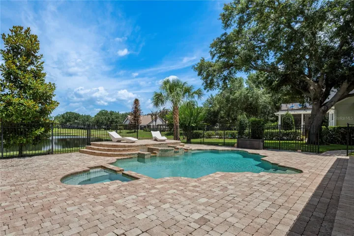 Spacious cobblestone pool deck.