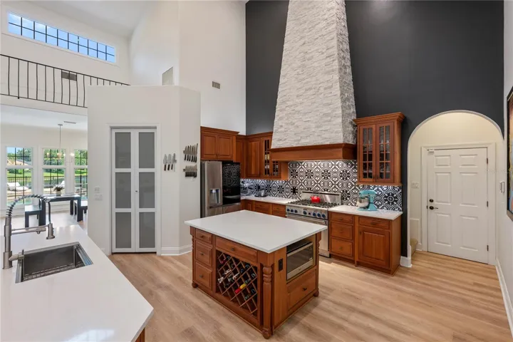 Pretty shot!   Kitchen with garage door to right, and view to pool & pond to left