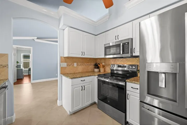 Tile backsplash and crown molding throughout