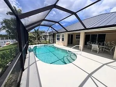 Sparkling blue pool overlooking the sailboat canal