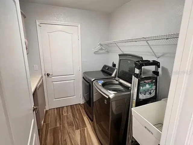 Interior Laundry room with washer and dryer, and laundry tub.