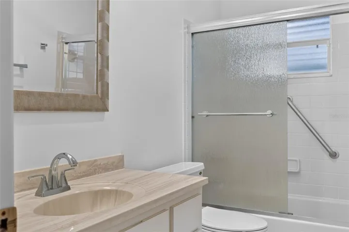 Hall Bath with Glass Sliders on Tub