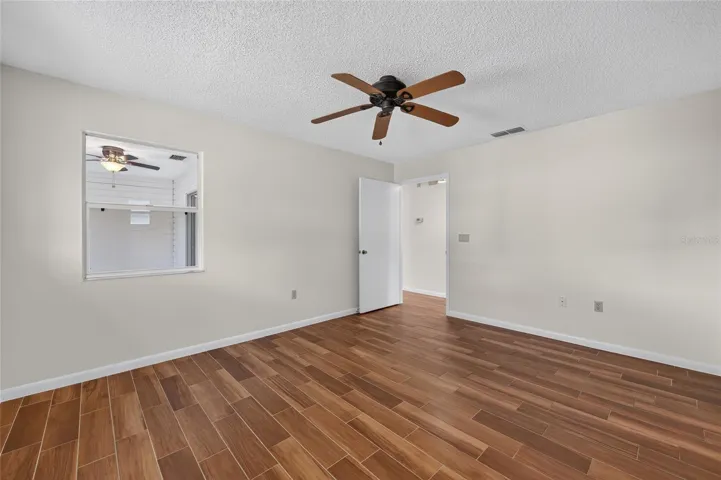 Primary Bedroom with Window to Florida room