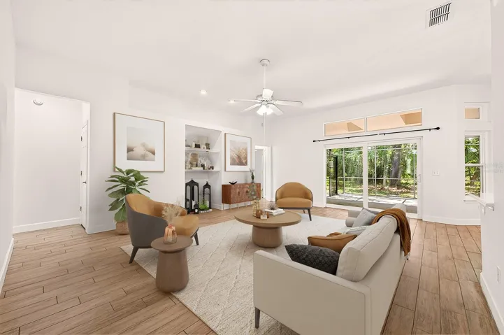 Gather with family or entertain friends in the living area, sliding glass doors out to the extended lanai offer the ultimate in indoor/outdoor Florida living. Virtually Staged.