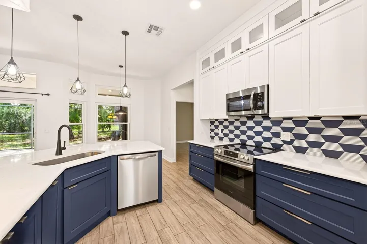 Beautifuly updated kitchen offers stainless steel appliances and quartz counters.