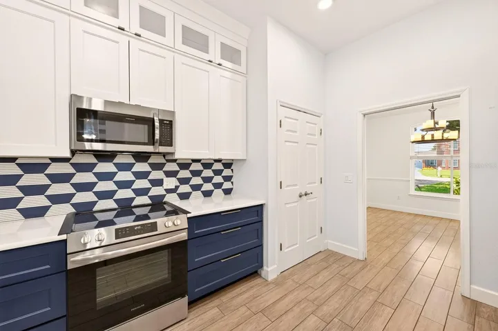 Beautifuly updated kitchen offers stainless steel appliances and quartz counters.