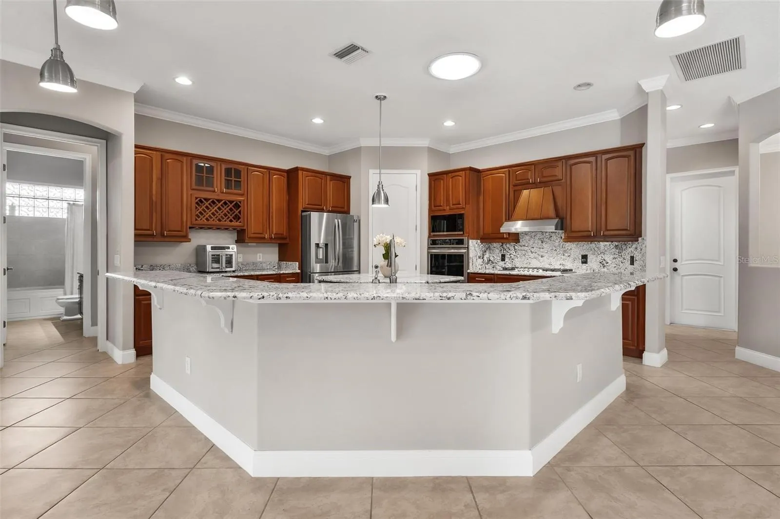 Spacious breakfast bar, beautifully finished with granite countertops that combine style and functionality...