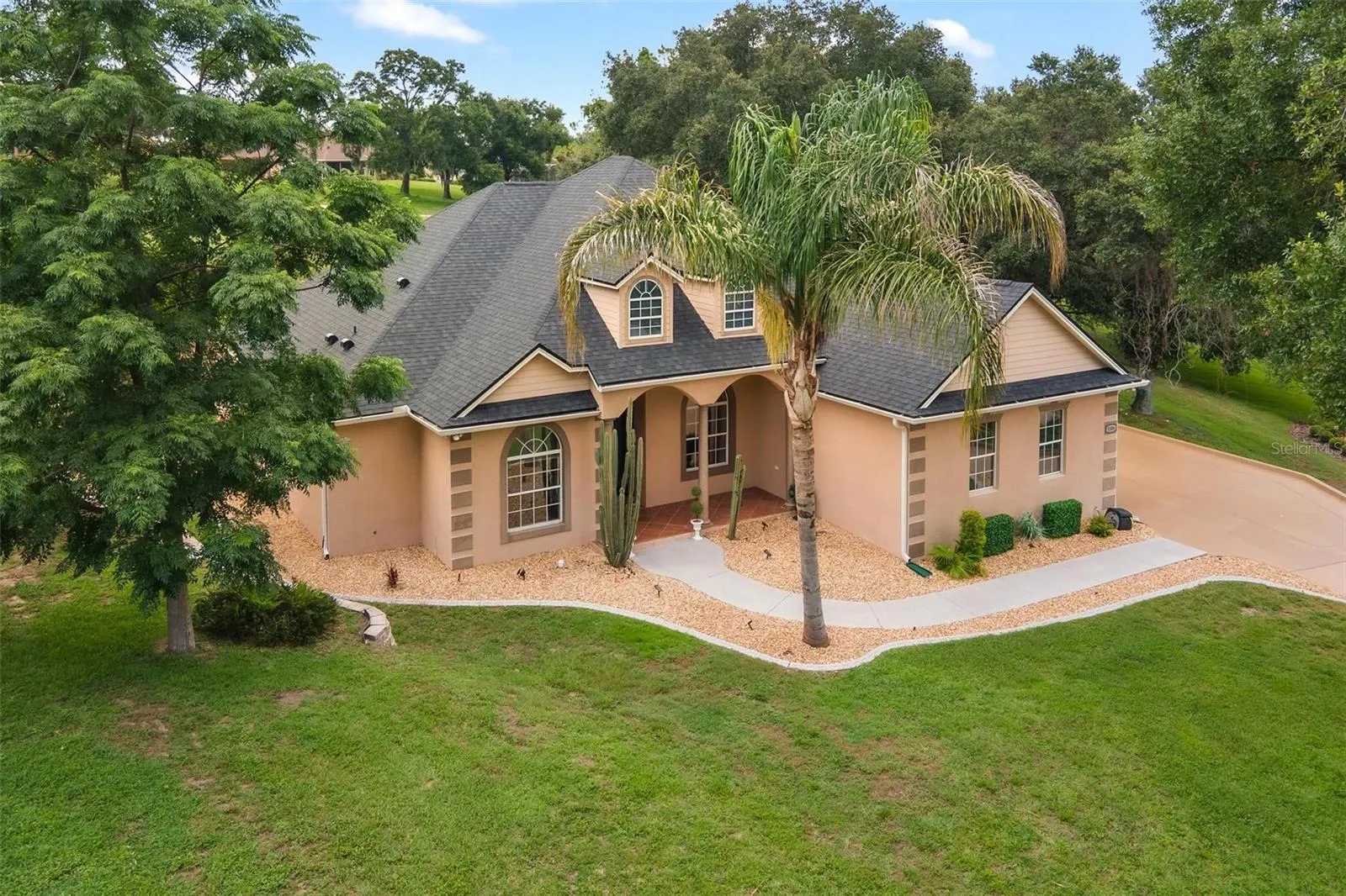 Take in the full beauty of the property from above, surrounded by mature trees and well-maintained landscaping.