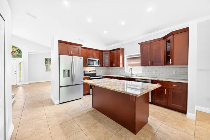 The interior delivers a light-filled floor plan with formal living and dining spaces at the front of the home, enhanced by crown molding throughout the first floor.
