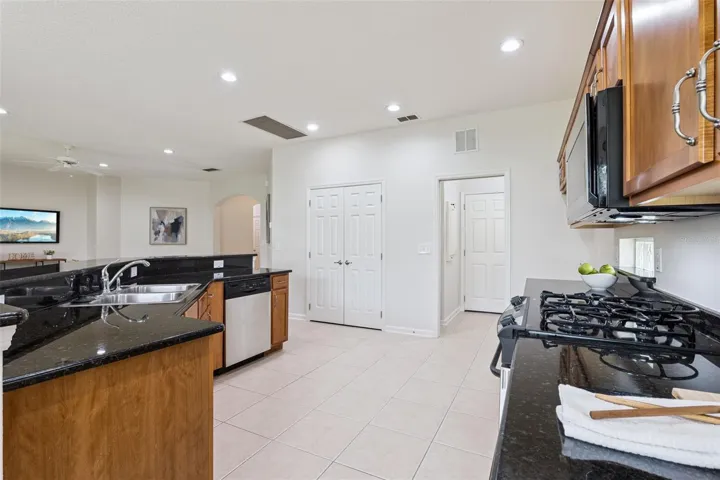 View of the large Kitchen pantry closet & Utility Room w/ a pocket door