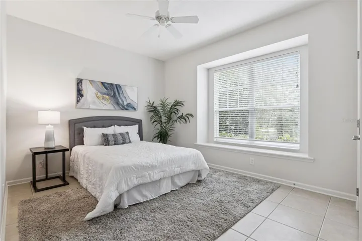 13' x 11' Bedroom #3 w/ ceramic tile floor, window seat & a ceiling fan