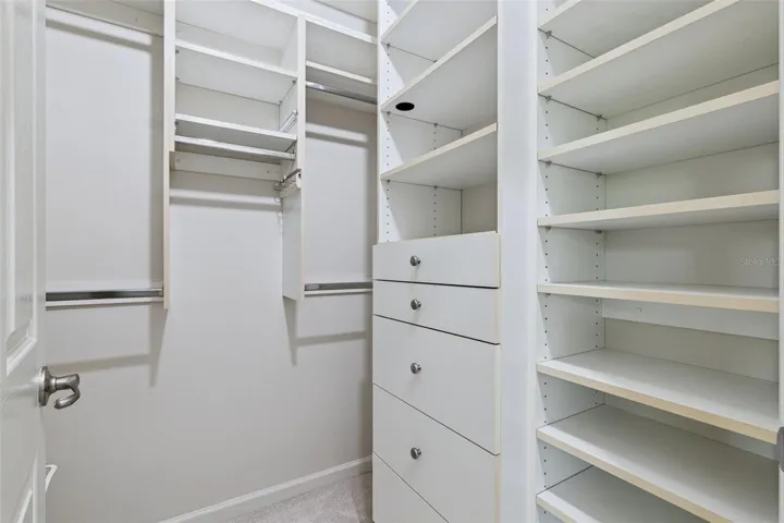 1 of 2 walk-in closets w/ organizers for the Primary Bedroom