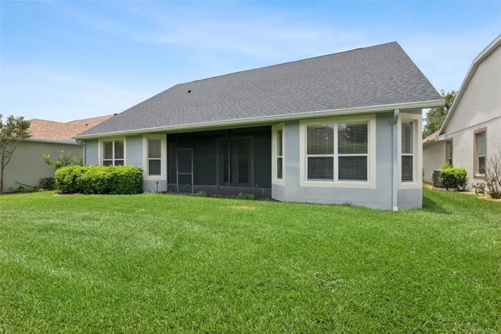 View of the spacious backyard & rear of the home