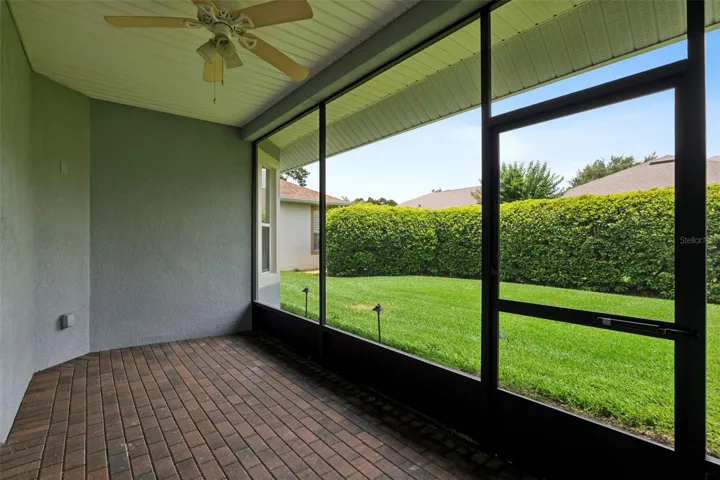 17' x 8' Screen enclosed covered patio w/ brick pavers & a ceiling fan