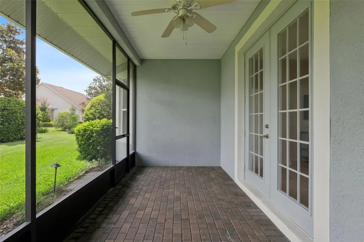 Screen enclosed covered patio w/ double French doors leading into the Great Room