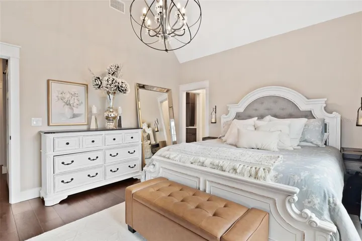 Primary Suite features high ceilings, French door leading to pool area, and Old English Wood flooring.