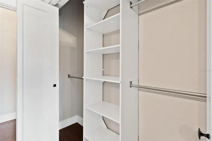 Closet features custom built-in's.