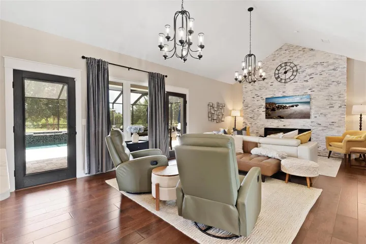 Anchoring the great room is a stunning floor-to-ceiling rock accent wall featuring an LED fireplace, creating a beautiful focal point & cozy gathering space.