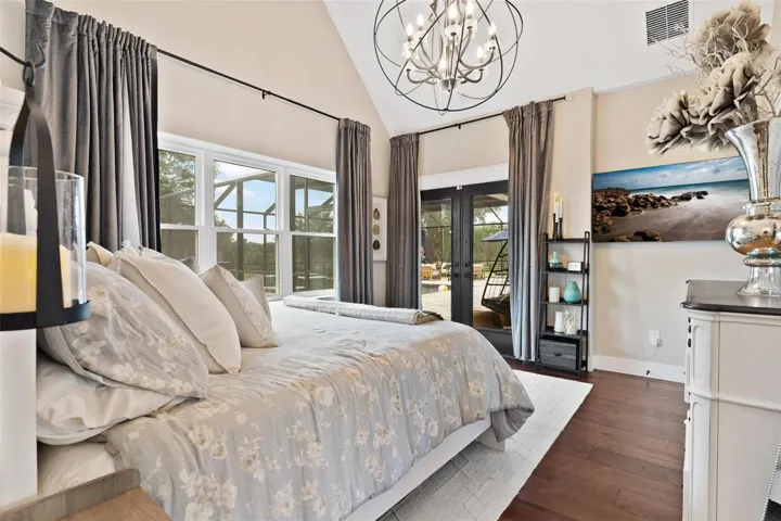 Primary Suite features high ceilings, French door leading to pool area, and Old English Wood flooring.