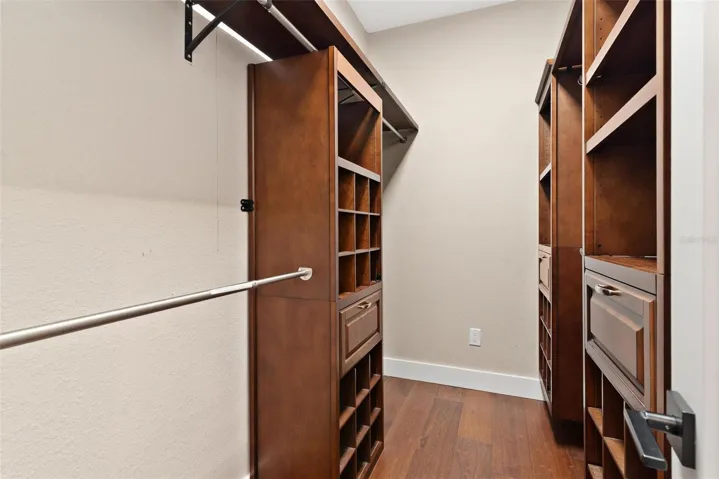 Walk in Primary Closet with custom built ins.