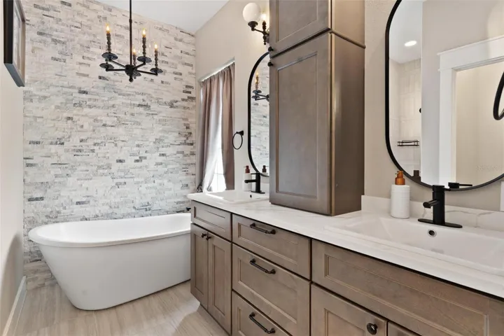 Primary Ensuite features dual vanity sinks with quartz, free standing tub, walk in shower.