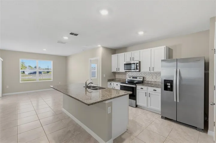 Granite countertops, stainless steel appliances and a breakfast bar