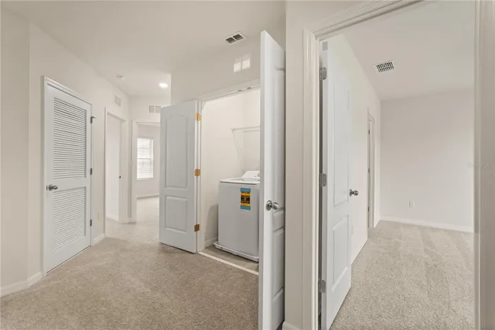 Loft landing with view to primary bedroom.
