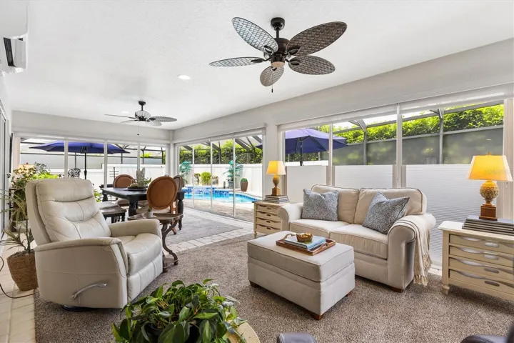 GLASS ENCLOSED LANAI UNDER HEAT/AIR-STACKED SLIDERS LEADING TO THE POOL AREA