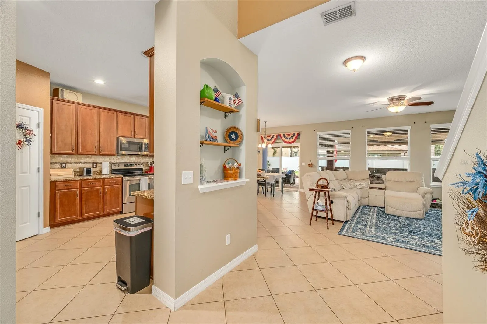 Kitchen to the left, dining nook and living room ahead, stairs to the right