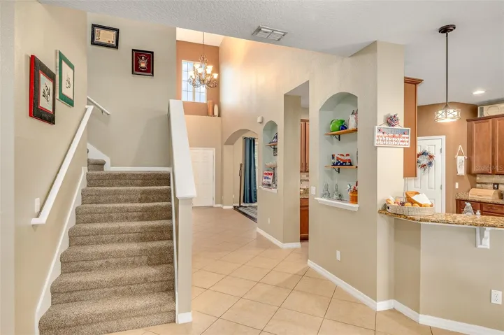 When exiting downstairs primary bedroom, staircase is on the left
