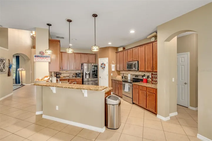 Breakfast bar, dining nook in front of bar; garage & laundry, full bathroom and extra bedroom off the side of the kitchen