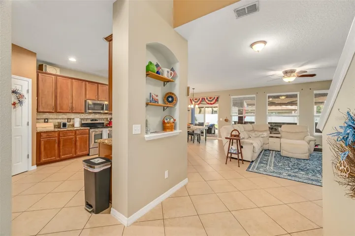 Kitchen to the left, dining nook and living room ahead, stairs to the right