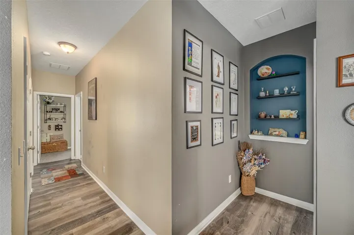 Hallway to additional Primary Suite to the right and additional 2 bedrooms and bathroom to the left