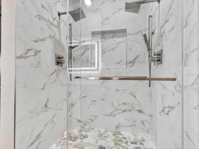 Renovated bathroom with three shower heads