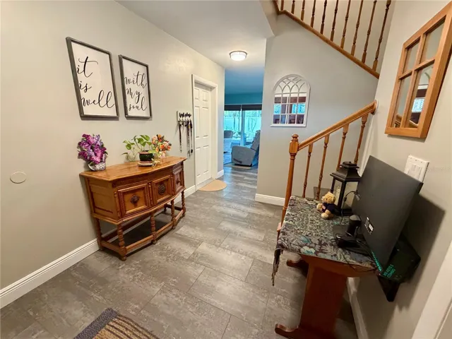 Stairs from the foyer lead to the living room, dining room and kitchen on main living level