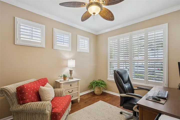 Downstairs OFFICE with double doors, plantation shutters, and crown molding