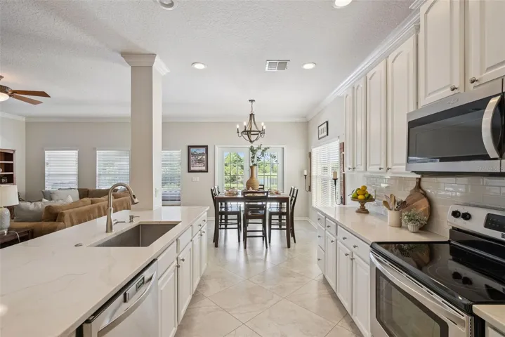 Updated Kitchen with quartz counters, stainless steel appliances, one large sink, plethora of storage....