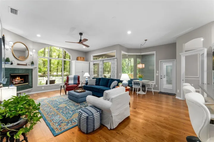 Family room with large windows looking towards trees and golf course