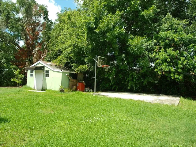 Large, fenced backyard with concrete pad.