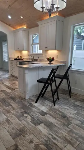 Custom wood ceiling in your beautiful Kitchen with lots of cabinets, gorgeous quartzite counters, deep farmhouse sink and breakfast seating. PLUS a seperate Dinette and HUGE pantry!