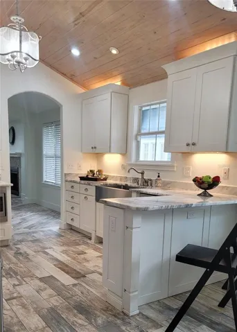 Custom wood ceiling in your beautiful Kitchen with lots of cabinets, gorgeous quartzite counters, deep farmhouse sink and breakfast seating. PLUS a seperate Dinette and HUGE pantry!