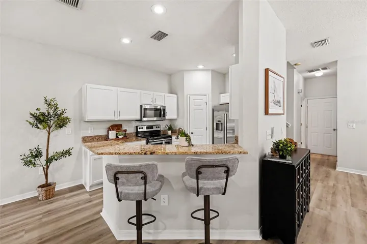Eat in kitchen space, fits one more chair!